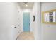 Bright hallway with tile flooring, a vibrant blue door, and modern decorative accents at 2041 N 88Th St, Mesa, AZ 85207