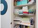 Organized linen closet with shelves stocked with towels, boxes and an iron at 2041 N 88Th St, Mesa, AZ 85207