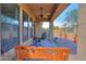Inviting covered patio featuring a ceiling fan, comfortable seating and views of the backyard landscaping at 2041 N 88Th St, Mesa, AZ 85207
