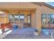 Beautiful covered patio with ceiling fan, seating, and convenient access to the home's interior at 2041 N 88Th St, Mesa, AZ 85207