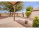 Backyard featuring a covered patio, storage shed, and low-maintenance landscaping at 20449 N 105Th Ave, Peoria, AZ 85382