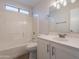 Bright bathroom with a shower-tub combo, toilet, vanity and large mirror at 20449 N 105Th Ave, Peoria, AZ 85382