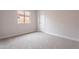 Bedroom with neutral carpet, a window for natural light and a closet door at 20449 N 105Th Ave, Peoria, AZ 85382
