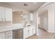 Spacious kitchen with white cabinets, stainless steel appliances, quartz counters, and views to the living area at 20449 N 105Th Ave, Peoria, AZ 85382