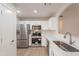 Bright kitchen featuring stainless steel appliances, white cabinets and countertops, and a pass-through at 20449 N 105Th Ave, Peoria, AZ 85382