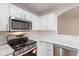 Close up of kitchen featuring stainless steel appliances, white cabinets and countertops, and modern finishes at 20449 N 105Th Ave, Peoria, AZ 85382