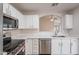 Kitchen featuring stainless steel appliances, white cabinets and countertops, and an arched passthrough at 20449 N 105Th Ave, Peoria, AZ 85382