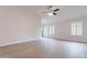 Bright living room featuring contemporary flooring, recessed lighting and plantation shutters on the large windows at 20449 N 105Th Ave, Peoria, AZ 85382