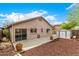 Backyard features a patio, privacy fence, shade tree and storage shed at 23006 W Cantilever St, Buckeye, AZ 85326