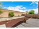 Spacious backyard featuring a patio, privacy fence, stone mulch garden and greenery at 23006 W Cantilever St, Buckeye, AZ 85326