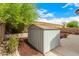 The backyard features a storage shed, rock garden, and patio with landscaping at 23006 W Cantilever St, Buckeye, AZ 85326