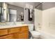 Bathroom features a wood vanity, full mirror, shower-tub combo and modern fixtures at 23006 W Cantilever St, Buckeye, AZ 85326