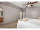 Spacious bedroom with wood floors, two closets, and access to the ensuite bathroom at 23006 W Cantilever St, Buckeye, AZ 85326