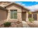 Home exterior featuring a secured front entrance and desert landscaping at 23006 W Cantilever St, Buckeye, AZ 85326