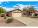 Single-story home with a two car garage and low-maintenance desert landscaping at 23006 W Cantilever St, Buckeye, AZ 85326