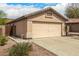 Two-car garage of home with desert landscaping in the front yard at 23006 W Cantilever St, Buckeye, AZ 85326