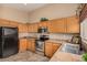 Bright kitchen featuring stainless steel appliances, light oak cabinetry, and tile flooring at 23006 W Cantilever St, Buckeye, AZ 85326