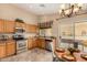 Well-equipped eat-in kitchen with stainless steel appliances and a view to the backyard at 23006 W Cantilever St, Buckeye, AZ 85326