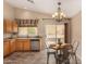 Eat-in kitchen area with stainless steel appliances, light oak cabinetry, and backyard access at 23006 W Cantilever St, Buckeye, AZ 85326