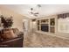 Living room with tile flooring and a ceiling fan at 23006 W Cantilever St, Buckeye, AZ 85326