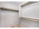 Empty walk-in closet with built in wooden shelves and gray walls at 23006 W Cantilever St, Buckeye, AZ 85326