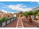 Backyard featuring a patio area with a covered bar, garden beds, desert vegetation and brick pathway at 23040 W Hammond Ln, Buckeye, AZ 85326