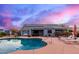 Relaxing backyard with a pristine pool, patio furniture, and lush landscaping under a vibrant sky at 23040 W Hammond Ln, Buckeye, AZ 85326