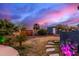 Landscaped backyard featuring decorative stone pathways, desert plants, and an outbuilding at 23040 W Hammond Ln, Buckeye, AZ 85326