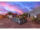 Beautiful backyard at dusk featuring a garden, pergola, and desert landscaping at 23040 W Hammond Ln, Buckeye, AZ 85326
