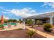 Lush backyard with a pool, patio, and desert landscaping at 23040 W Hammond Ln, Buckeye, AZ 85326