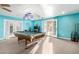Basement with a pool table, gym equipment, and access to an outdoor patio at 23040 W Hammond Ln, Buckeye, AZ 85326