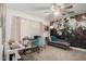 This bedroom features a desk, chaise lounge, ceiling fan, and creative mural on the wall at 23040 W Hammond Ln, Buckeye, AZ 85326
