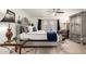 Elegant bedroom with a decorative grey four-poster bed, stylish curtains and a glass side table at 23040 W Hammond Ln, Buckeye, AZ 85326
