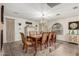 Elegant dining room with hardwood floors, decorative rug, a rustic chandelier and seating for eight at 23040 W Hammond Ln, Buckeye, AZ 85326