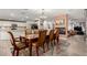Open-concept dining room with views to the fireplace, kitchen and breakfast bar seating for eight at 23040 W Hammond Ln, Buckeye, AZ 85326