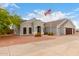 Attractive single-story home featuring a well-manicured desert landscape, spacious driveway, and three-car garage at 23040 W Hammond Ln, Buckeye, AZ 85326