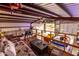 Spacious garage interior with a loft, visible vehicles, and an open door leading to the outdoors at 23040 W Hammond Ln, Buckeye, AZ 85326