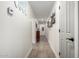 Hallway with light wood flooring and neutral walls leading to various rooms at 23040 W Hammond Ln, Buckeye, AZ 85326