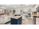 Spacious open kitchen flows into the breakfast and dining nook area with white cabinets and granite counters at 23040 W Hammond Ln, Buckeye, AZ 85326