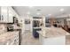 Open kitchen with stainless steel appliances, granite countertops, and a large center island with bar seating at 23040 W Hammond Ln, Buckeye, AZ 85326