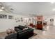 Open-concept living area featuring hardwood flooring, a fireplace, and modern furniture arrangements at 23040 W Hammond Ln, Buckeye, AZ 85326