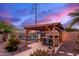 Stylish outdoor bar area with a pergola, bar stools, and a beautifully landscaped backyard at 23040 W Hammond Ln, Buckeye, AZ 85326