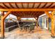 Inviting covered outdoor patio with dining set, fireplace, and flagstone flooring at 23040 W Hammond Ln, Buckeye, AZ 85326
