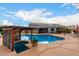 Backyard featuring a pool, covered patio, and desert landscaping at 23040 W Hammond Ln, Buckeye, AZ 85326