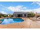 Backyard pool featuring solar panels, patio furniture, and lush landscaping at 23040 W Hammond Ln, Buckeye, AZ 85326