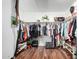 This walk-in closet boasts hardwood floors and ample storage space for clothing and shoes at 23040 W Hammond Ln, Buckeye, AZ 85326