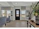 Light-filled entryway features tile floors, modern decor and a stylish black front door at 2541 E Presidio St, Mesa, AZ 85213