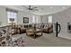 Comfortable living room featuring neutral colors, large windows, and a sectional sofa with decorative pillows at 2541 E Presidio St, Mesa, AZ 85213