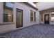 Charming courtyard with paver flooring, offering a private outdoor living space and multiple entry points to the home at 2636 E Virginia St, Mesa, AZ 85213