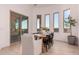 Elegant dining area with large windows, modern table setting, and easy access to outdoor spaces at 2636 E Virginia St, Mesa, AZ 85213